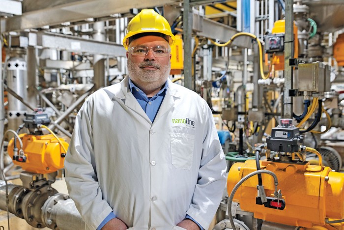 Denis Geoffroy stands in front of machinery at Nano One's lithium iron phosphate facility in Montreal.