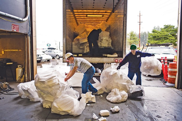 Workers unload discarded polystyrene foam from a truck at an Agilyx plant in Tigard, Ore.