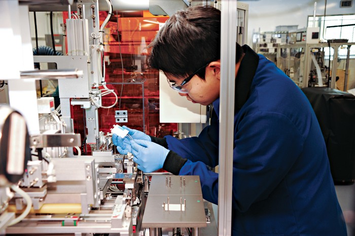 This photo shows a scientist at Argonne National Laboratory preparing pouch-type Li-ion batteries to study battery recycling. 09728-cover-argonnecxd.jpg