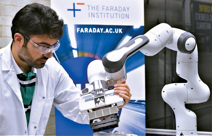 This photo shows a researcher at the University of Birmingham using a robotic arm to study Li-ion battery recycling. 09728-cover-roboticscxd.jpg
