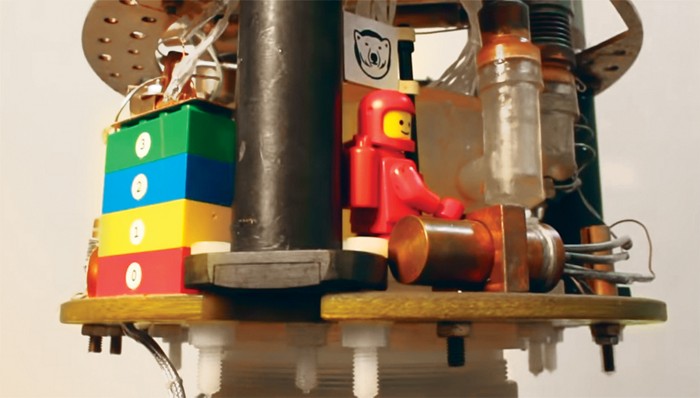 Video screenshot showing Lego bricks and a minifigure inside a dilution refrigerator. 09812-newscripts-screenshot.jpg