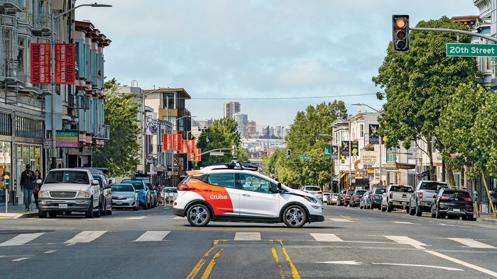 A hatchback with a thing on top sits in the middle of a San Francisco intersection. 09841-cover-cruise.jpg