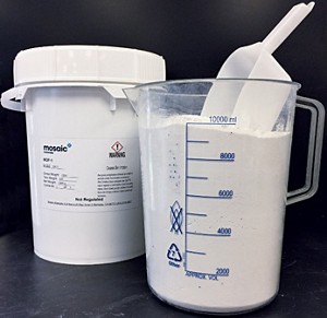 A beaker containing white powder. A canister, presumably holding the same material, sits nearby. 09926-cover-powder.jpg